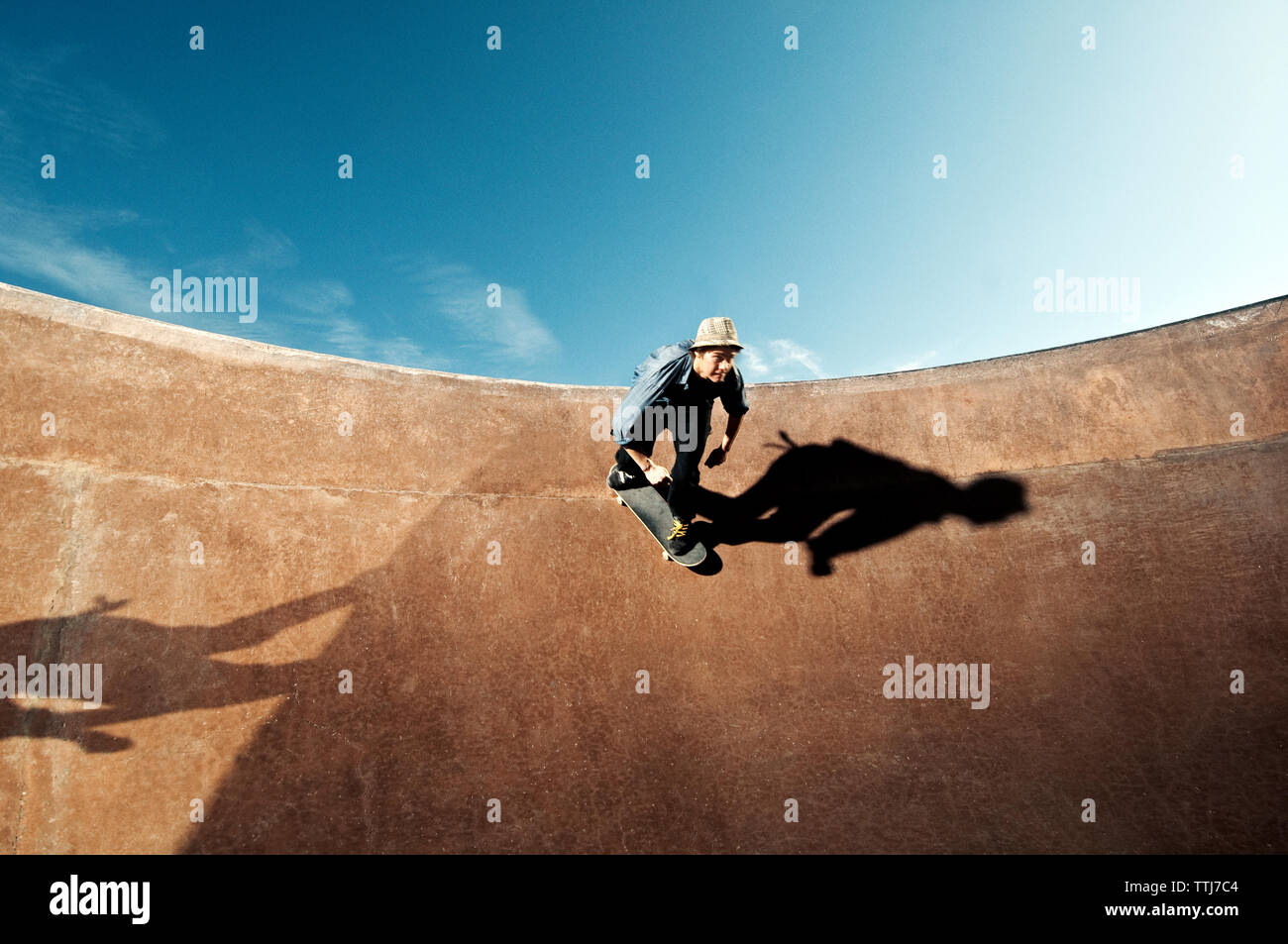 Low angle view of man skateboarding on skate ramp against sky Stock ...