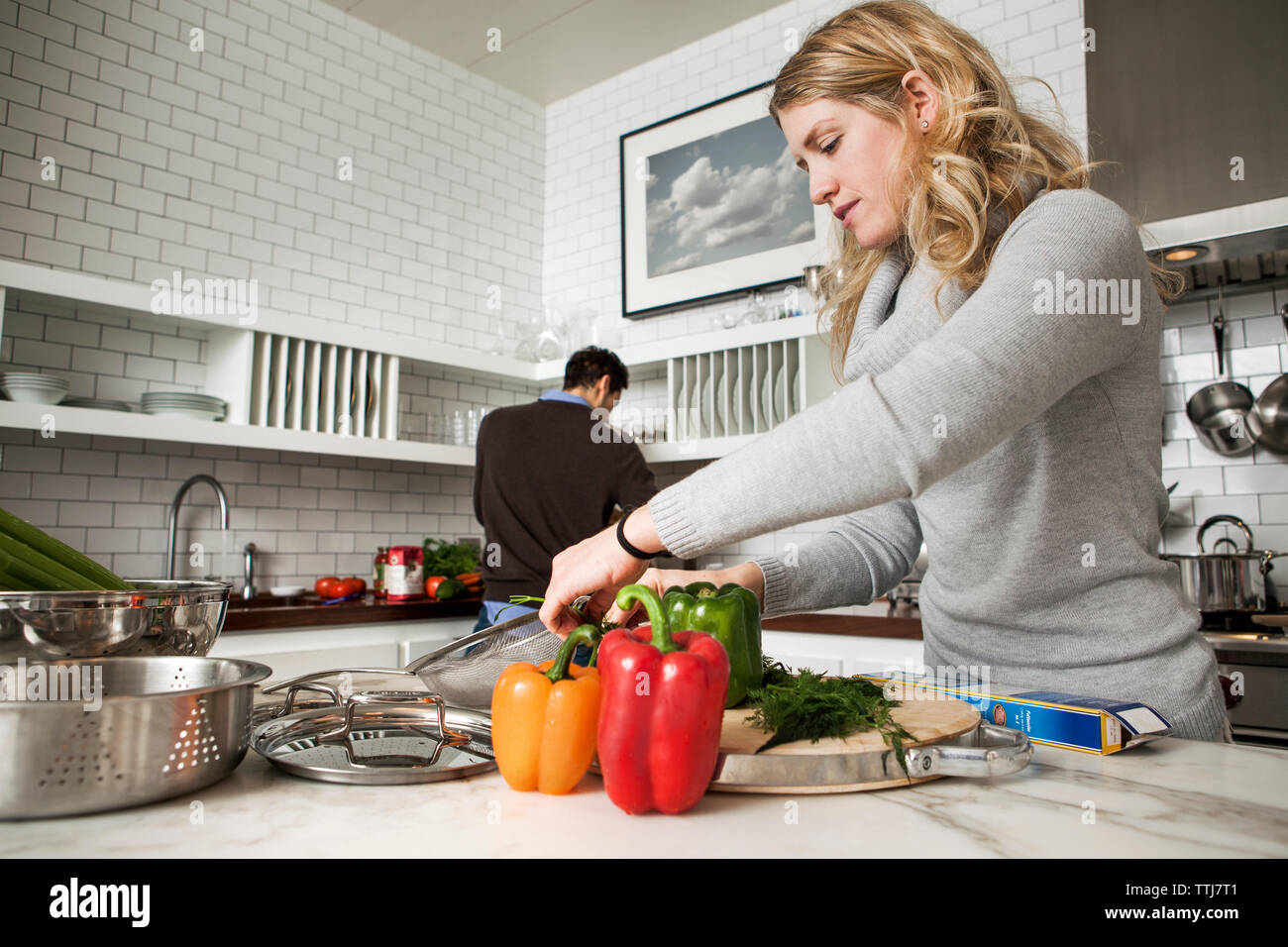 Couple preparing food in kitchen Stock Photo