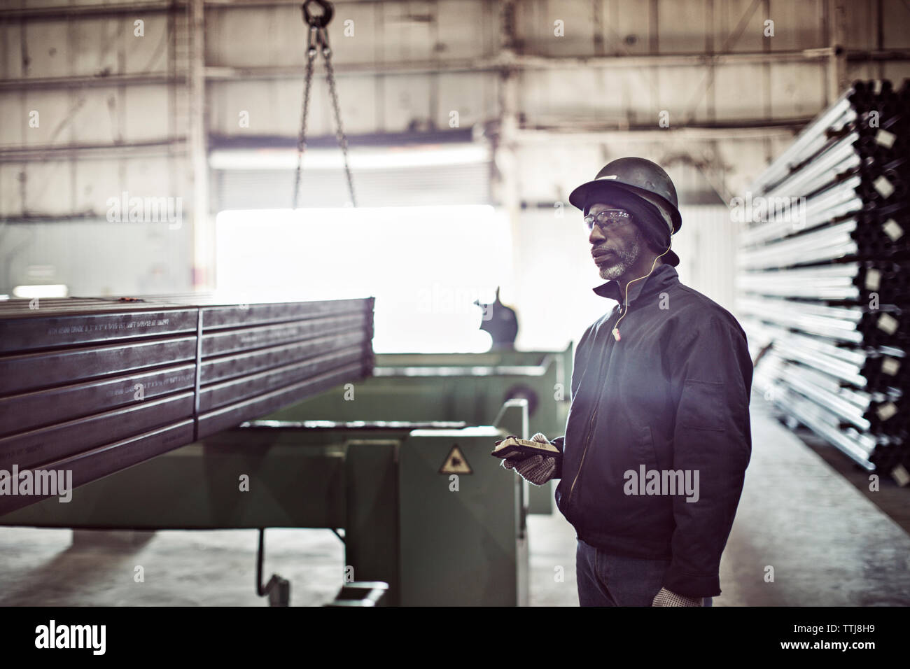 worker holding remote control in factory Stock Photo