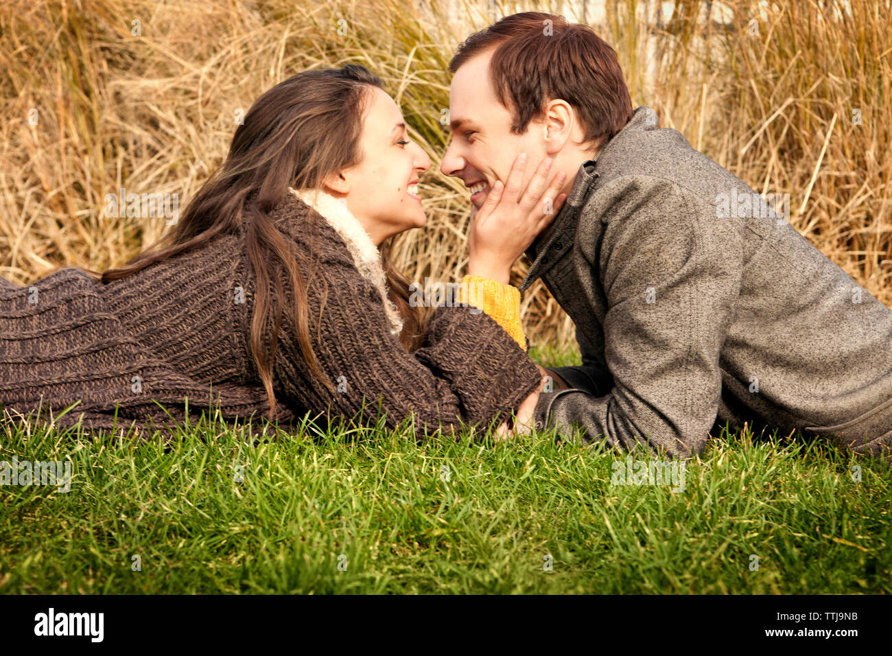 Couple lying on grass stock image. Image of people, friends 45127131