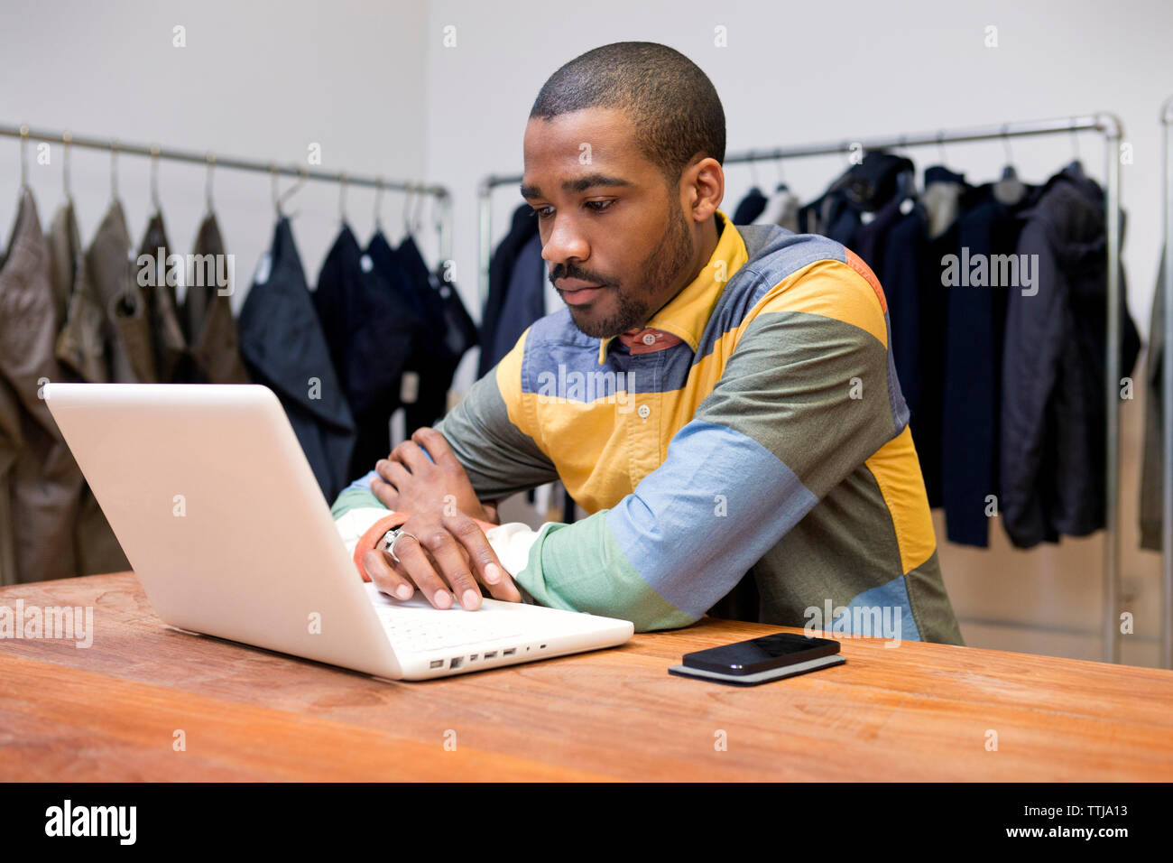 Designer using laptop computer in workshop Stock Photo