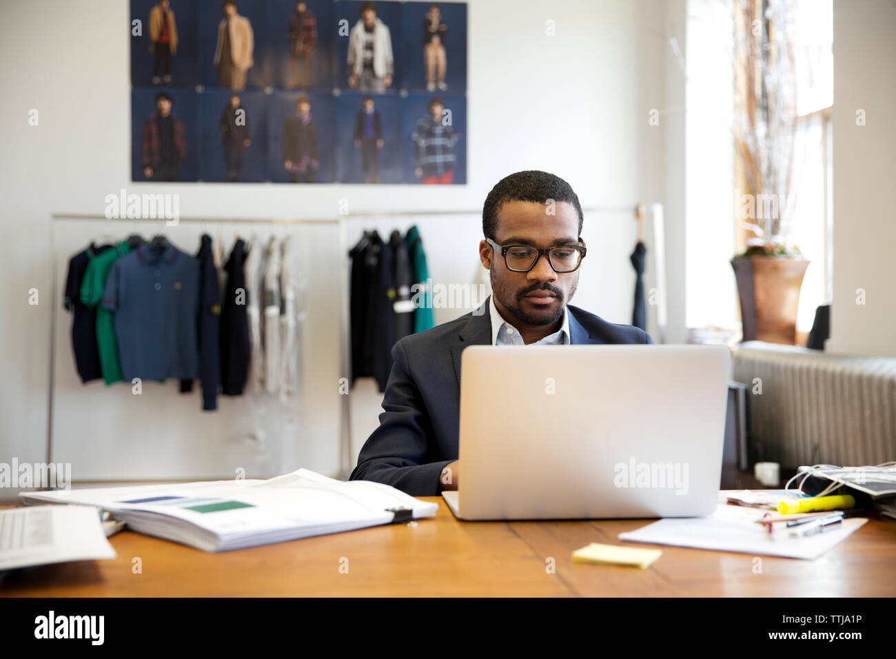businessman using laptop computer in workshop Stock Photo