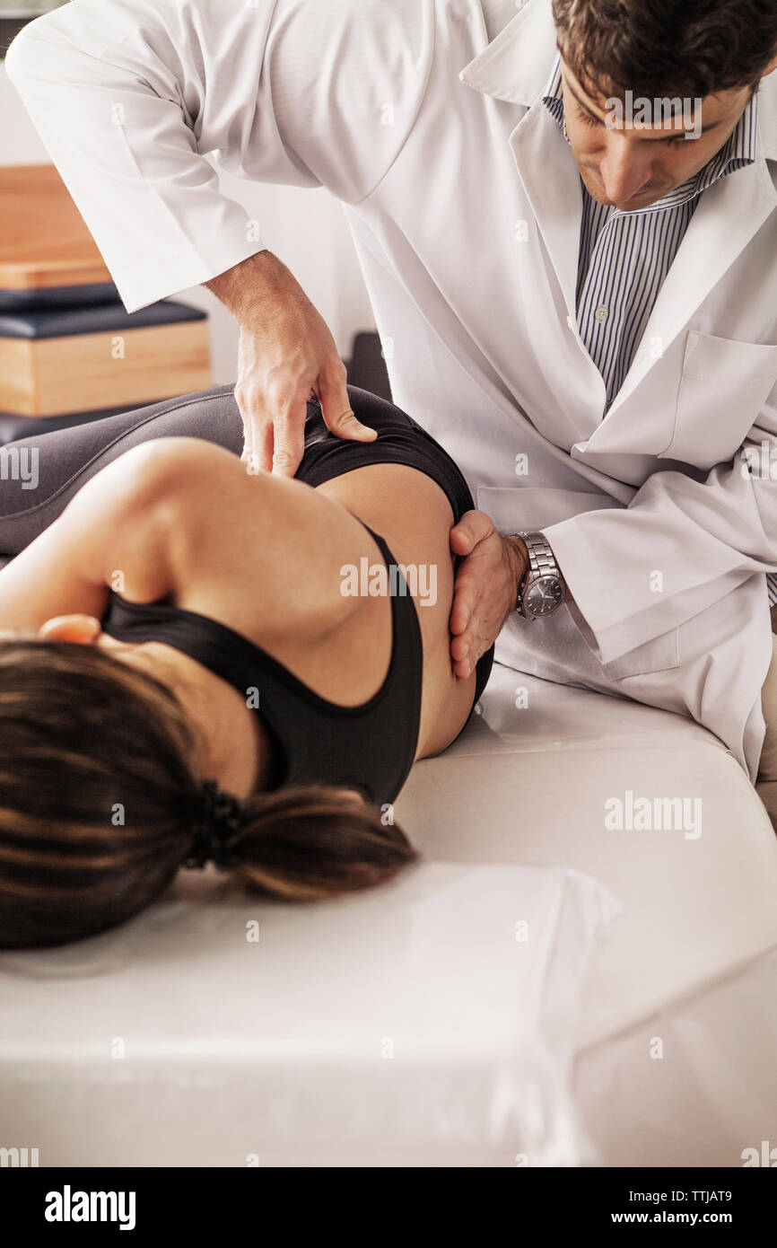 Woman being treated by physical therapist at clinic Stock Photo