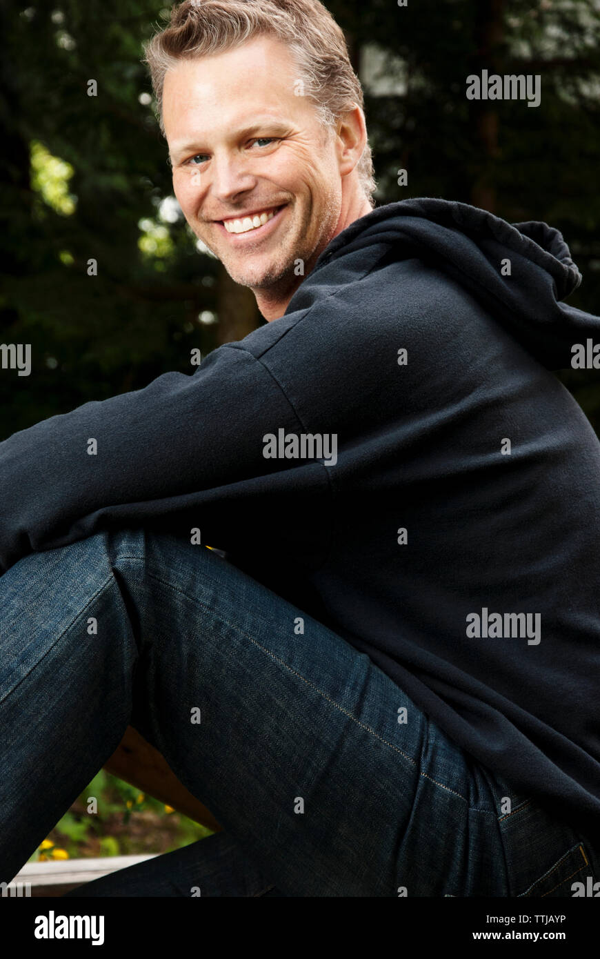 Happy man sitting outdoors hi-res stock photography and images - Alamy