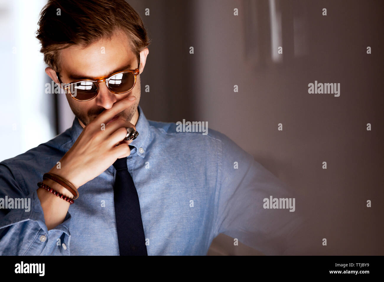 Man wearing sunglasses standing at home Stock Photo