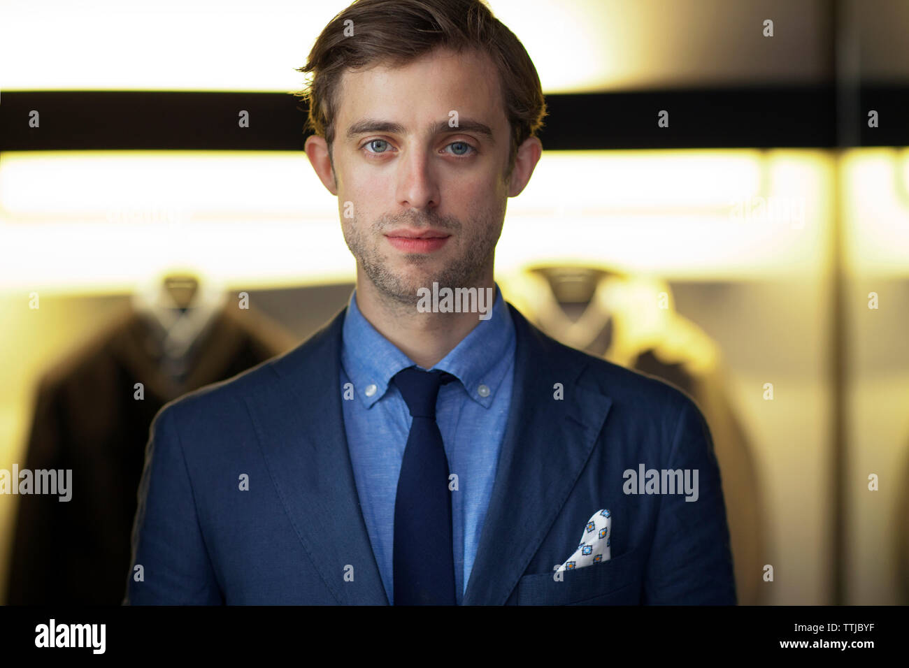Portrait of man in suit standing at home Stock Photo