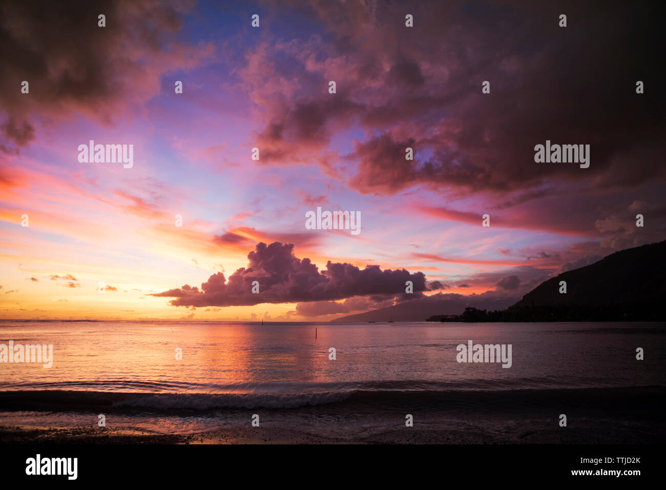 Scenic view of sea against cloudy sky during sunset Stock Photo - Alamy