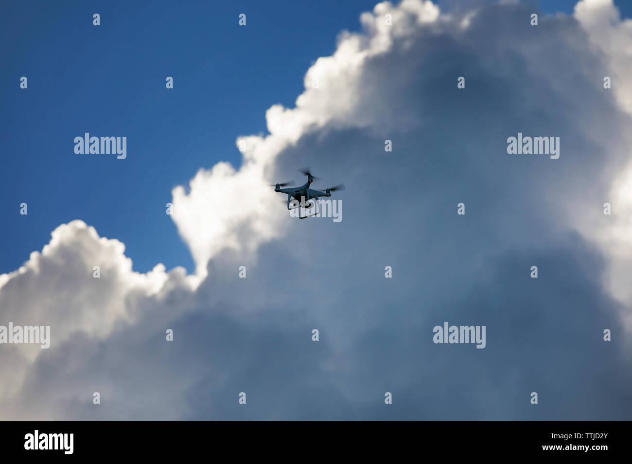 Low angle view of quadcopter against cloudy sky Stock Photo