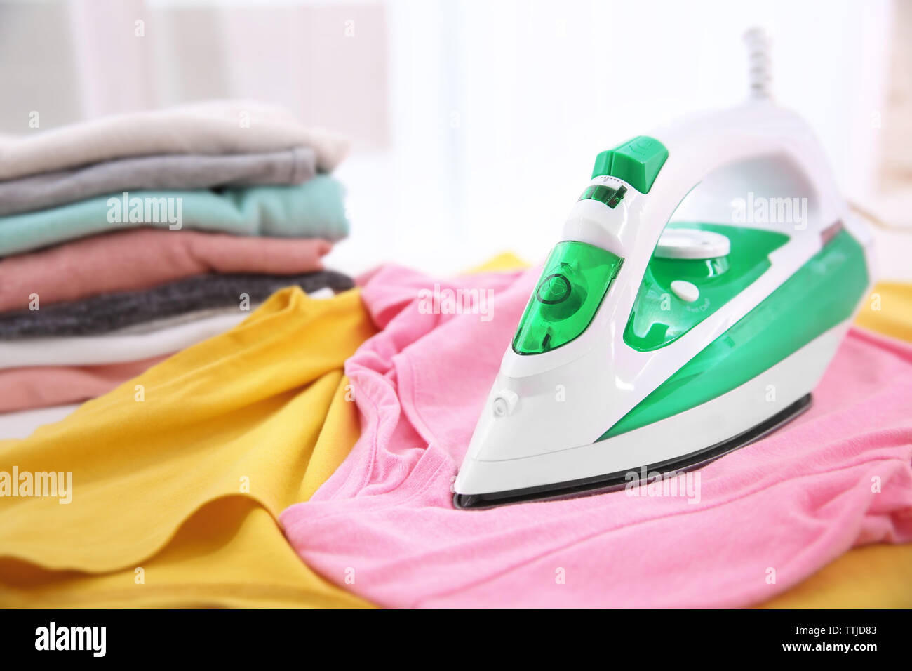 Iron and clothes indoors Stock Photo Alamy