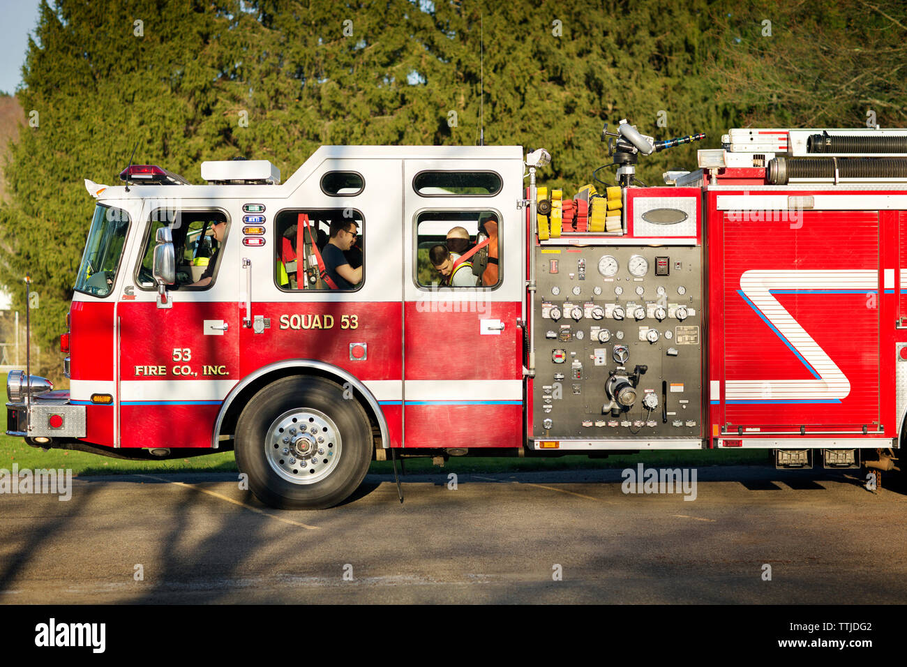Fire fighters sitting in fire engine Stock Photo