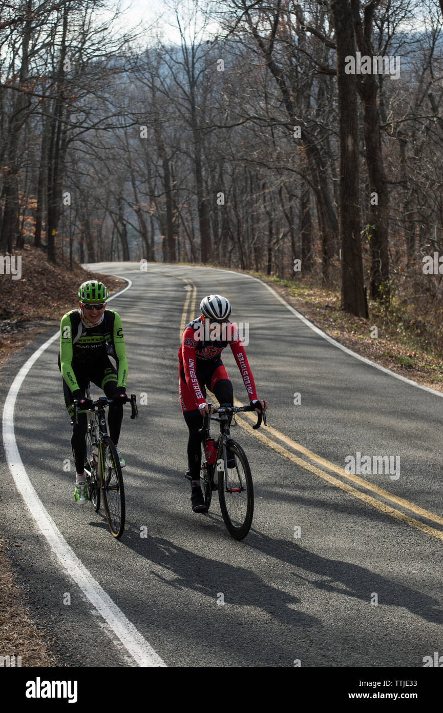 UNITED STATES - December 8, 2015: Pro cyclist Justin Mauch and Joe Dombrowski ride across Mt. Weather in the Blue Ridge Mountains of Virginia near Par Stock Photo