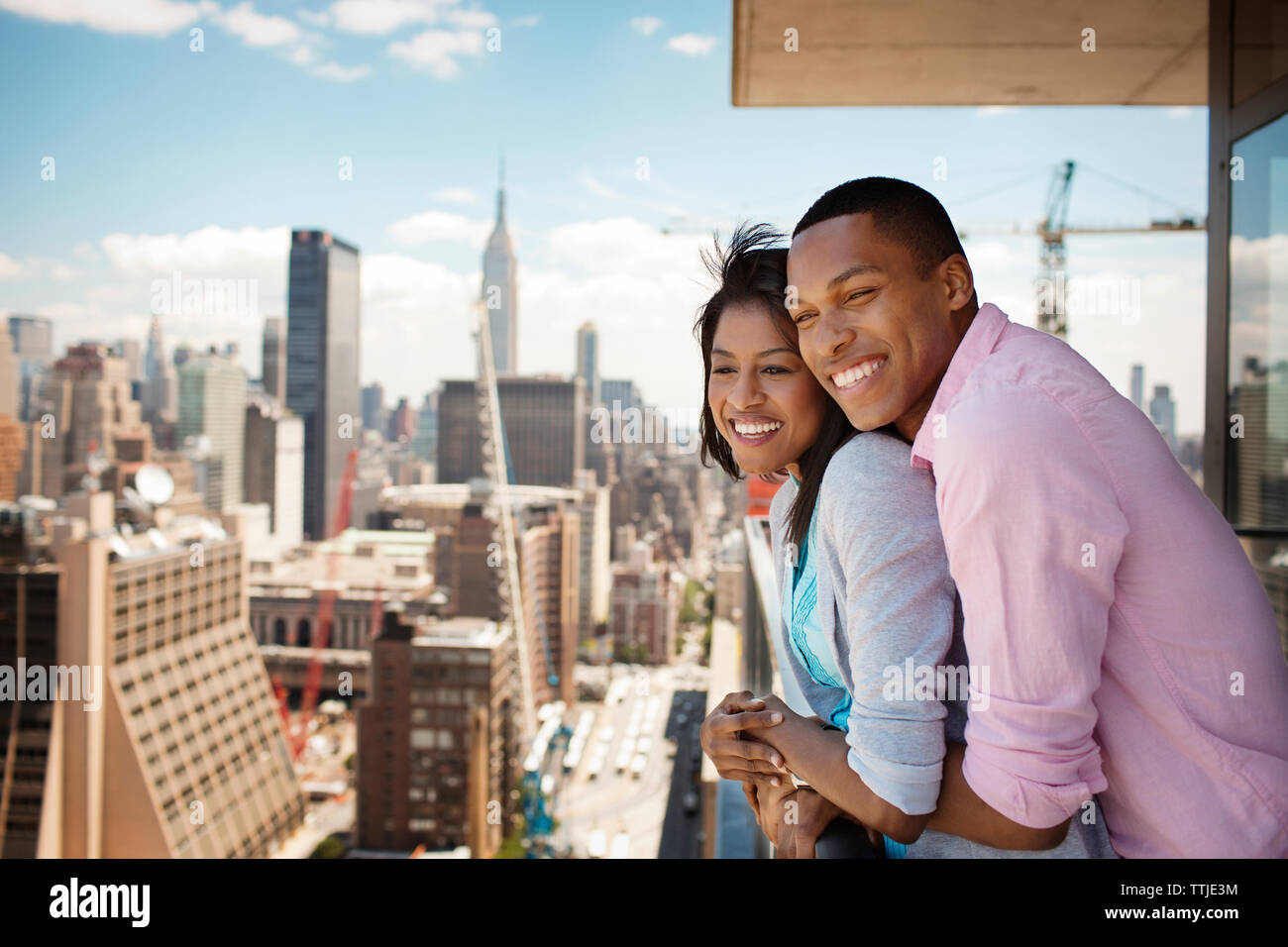 Business couple embracing in hotel balcony Stock Photo