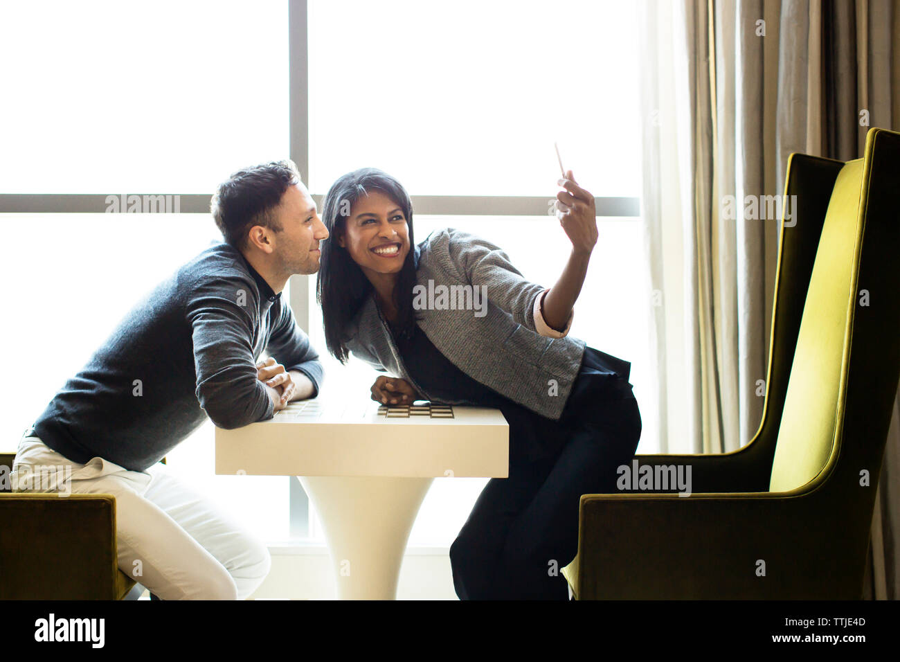 Colleagues taking selfie with tablet computer in office Stock Photo