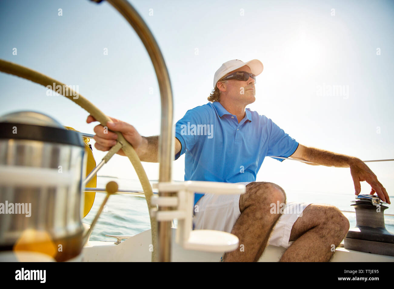 Full length of couple with arms around standing on yacht deck Stock Photo