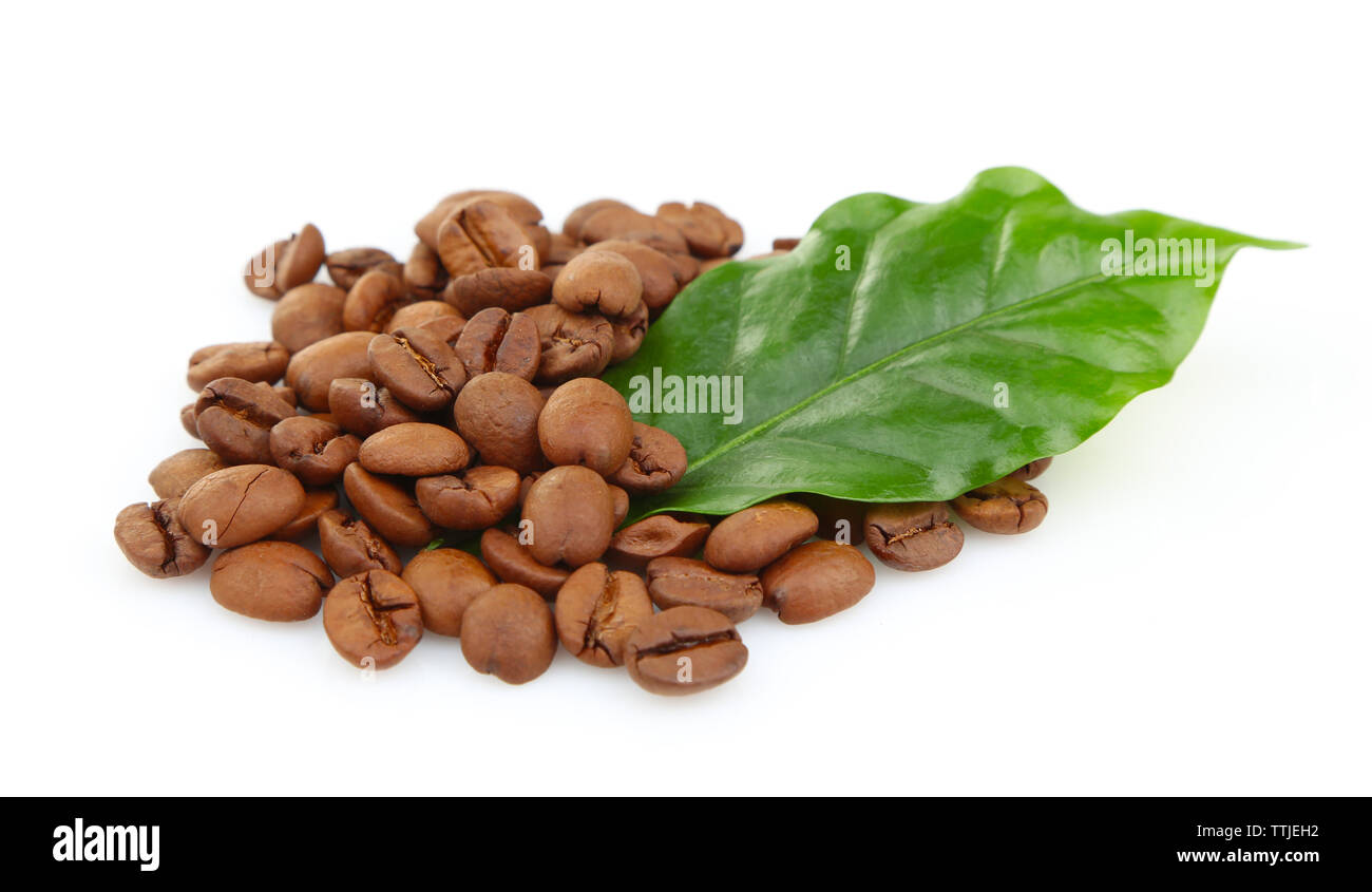 Coffee beans and green leaves, isolated on white Stock Photo - Alamy