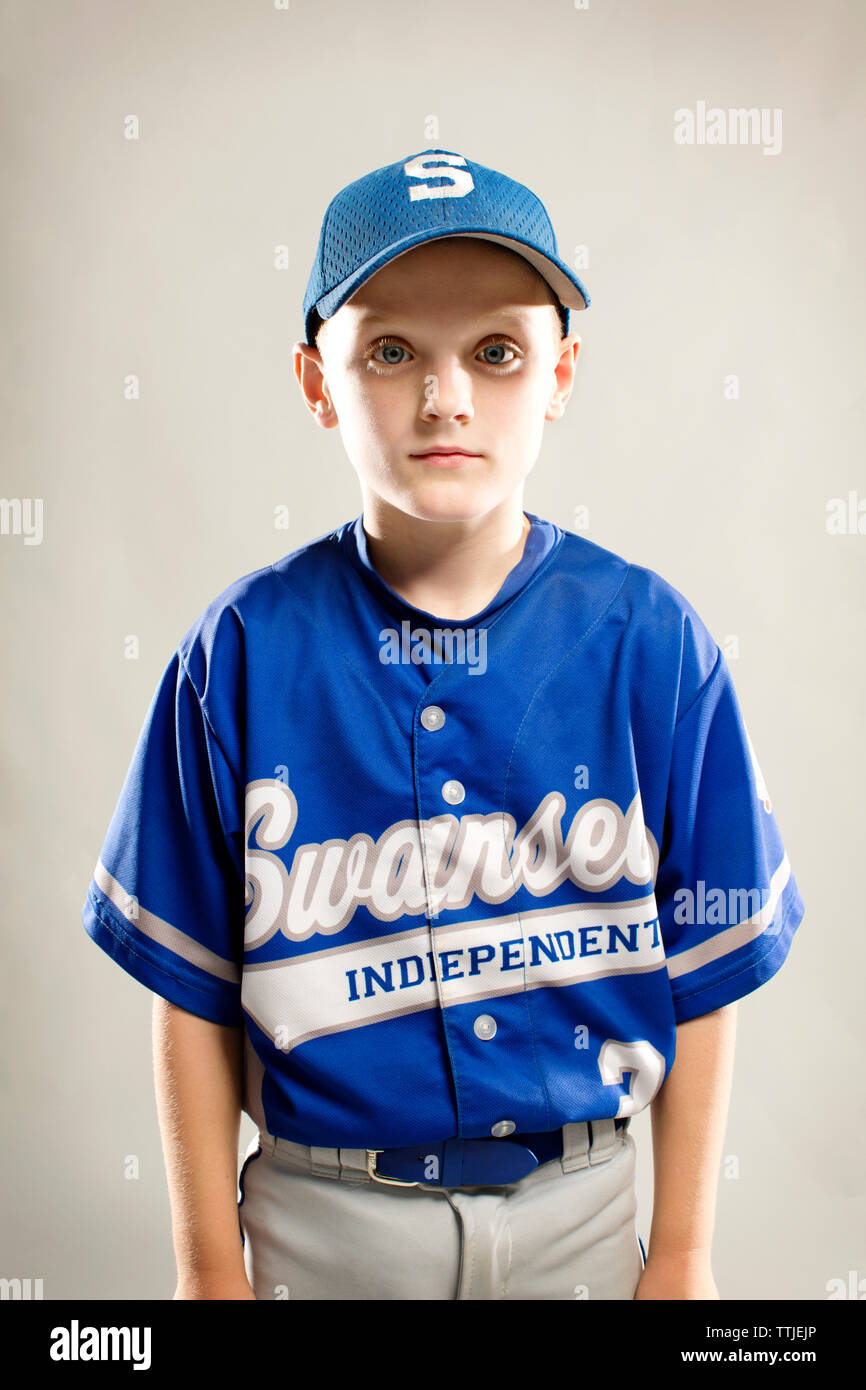 Portrait of baseball player standing against white background Stock Photo Alamy