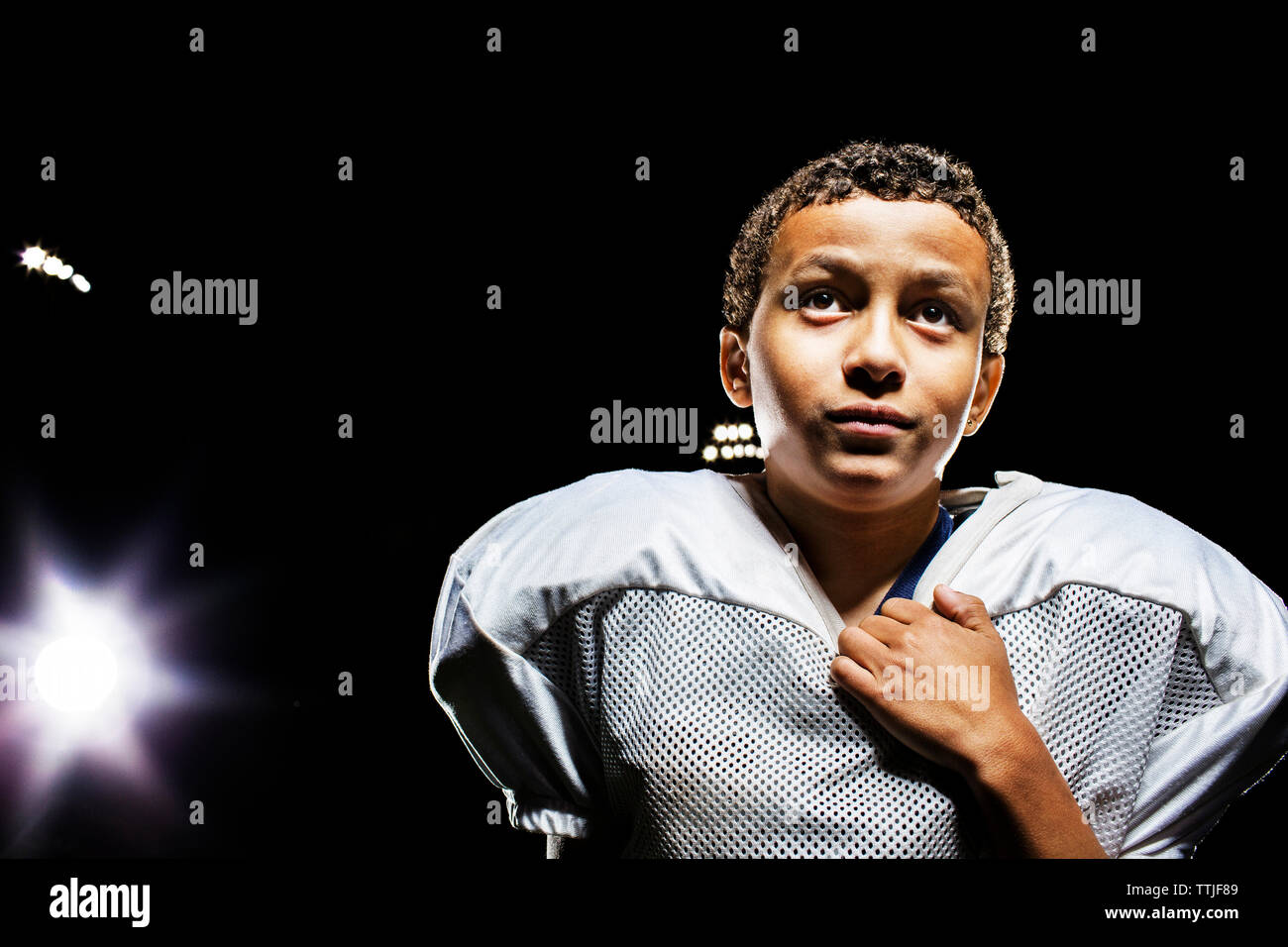 Player looking away while standing on field against sky Stock Photo