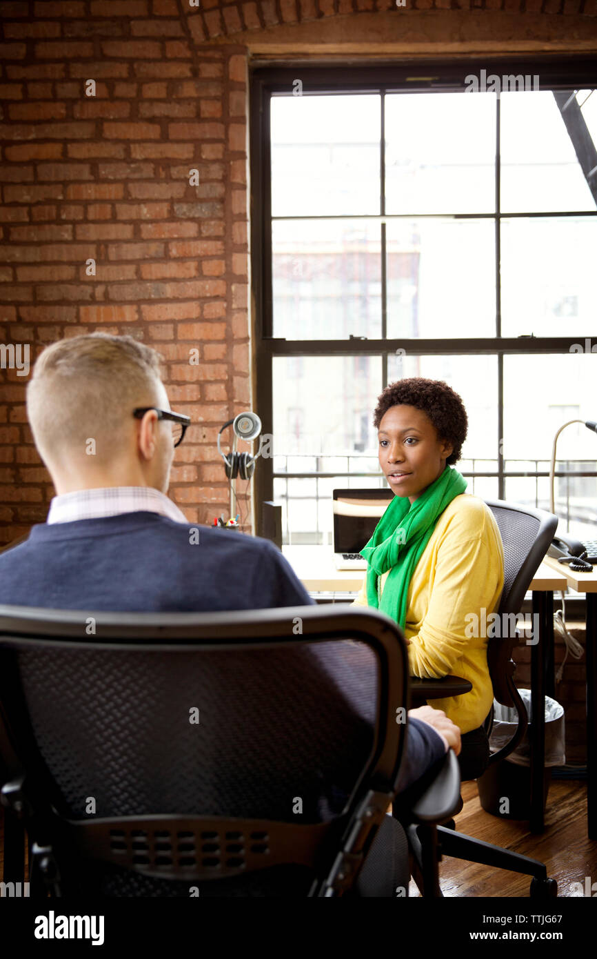Colleagues discussing in office Stock Photo