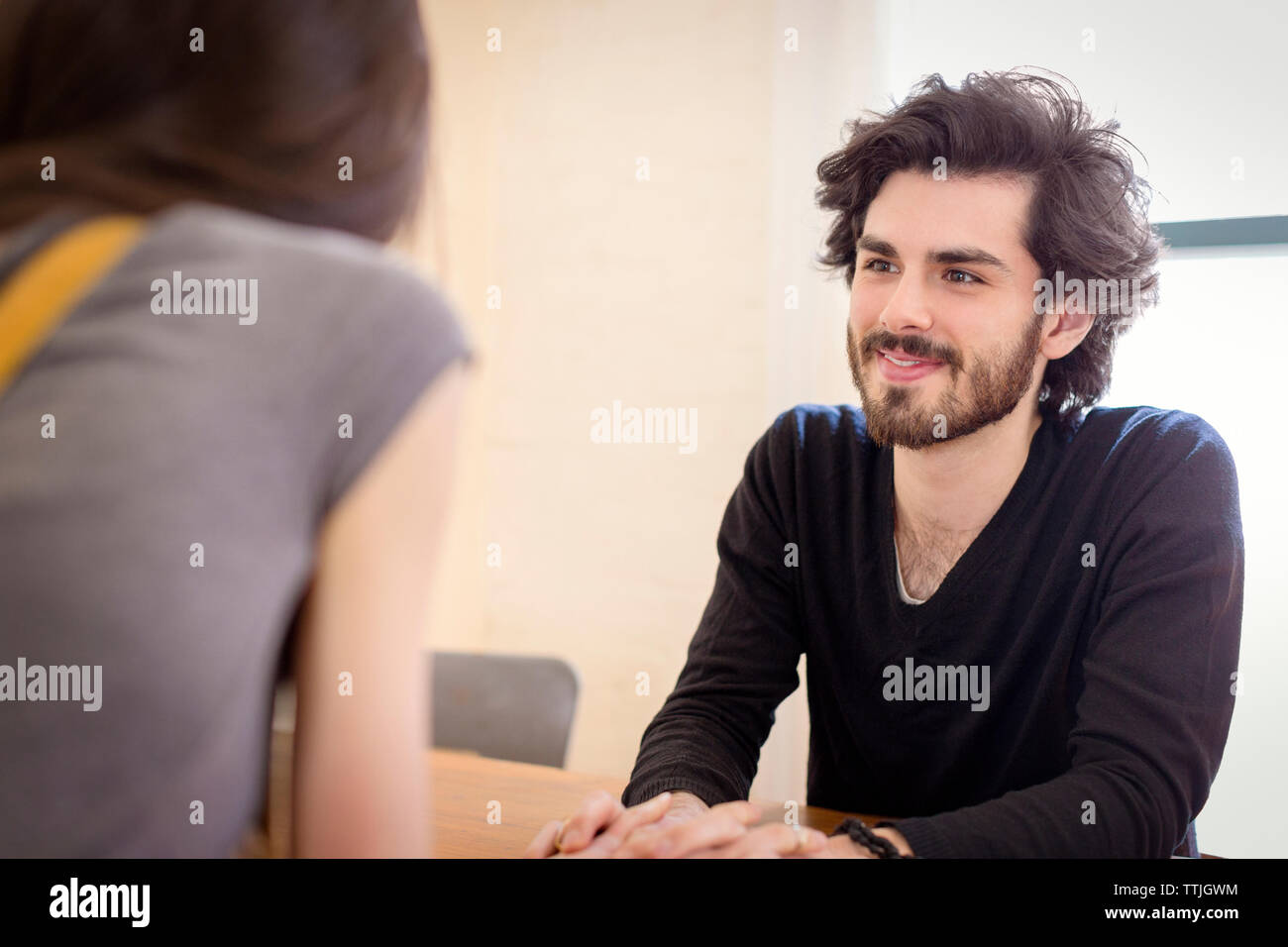 Woman sitting man rear table hi-res stock photography and images - Alamy