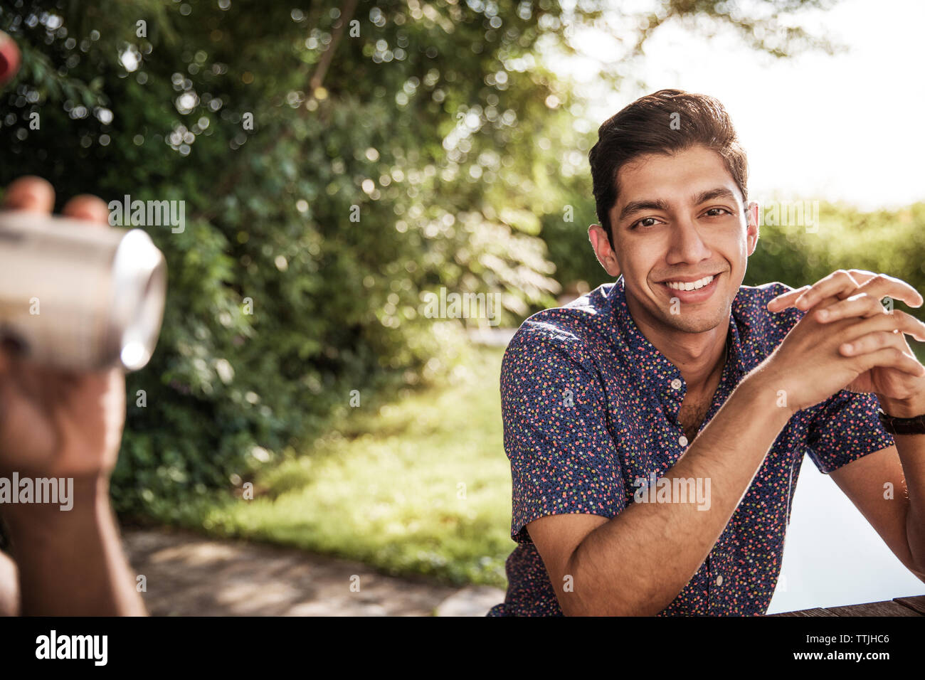 Happy asian man sitting hi-res stock photography and images - Alamy