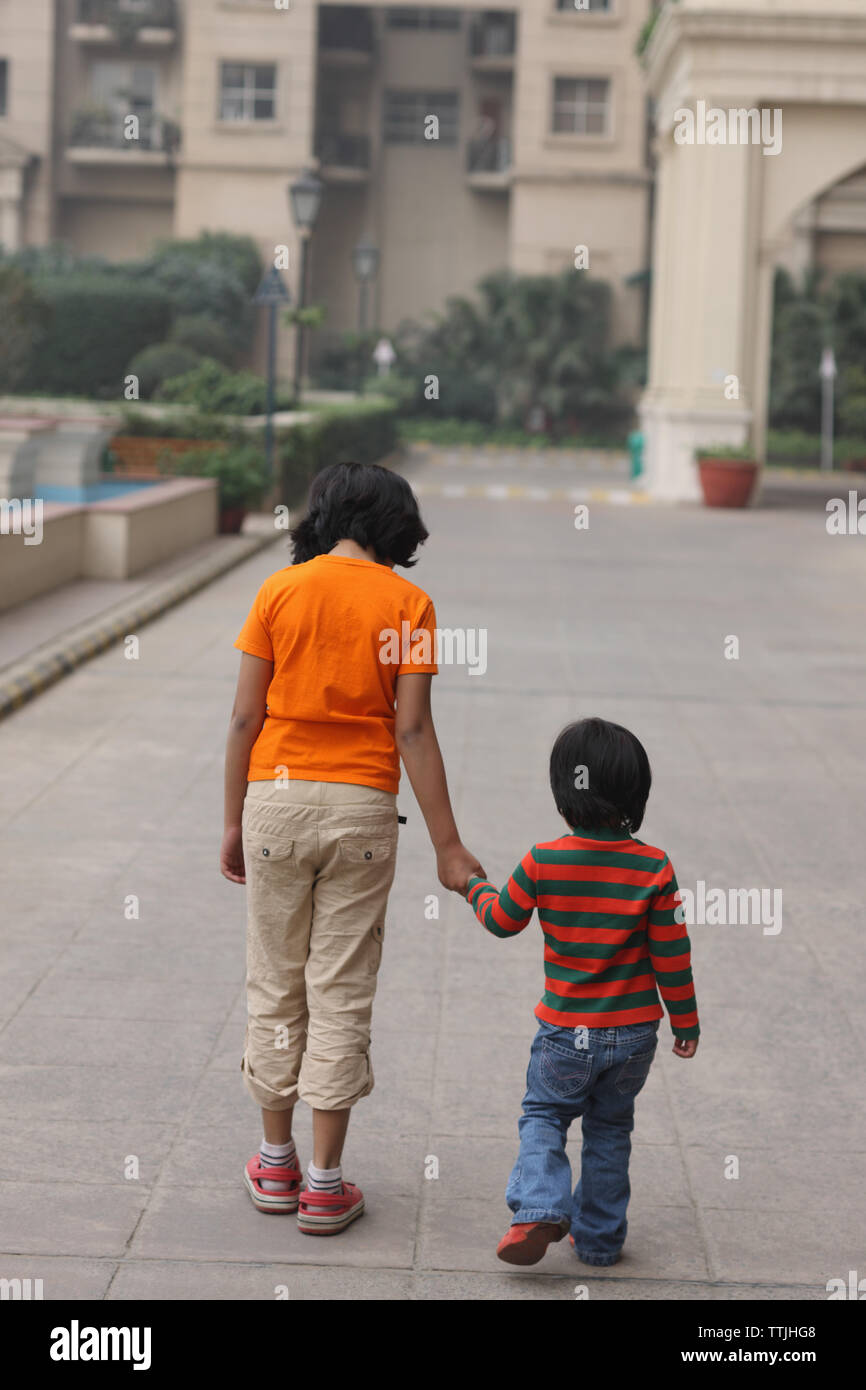 Rear view of two girls walking together Stock Photo - Alamy