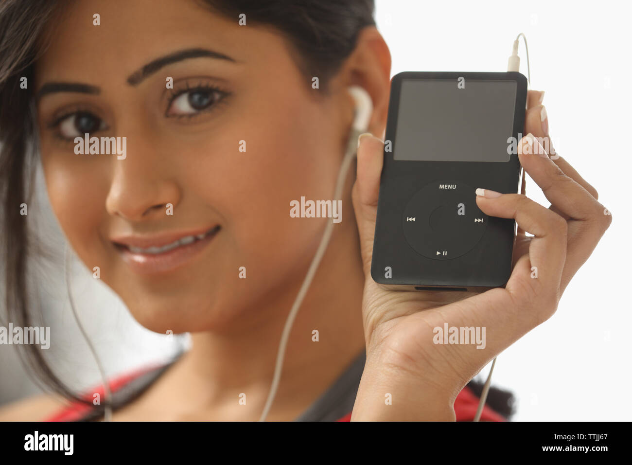 Indian woman listening to Mp3 player Stock Photo