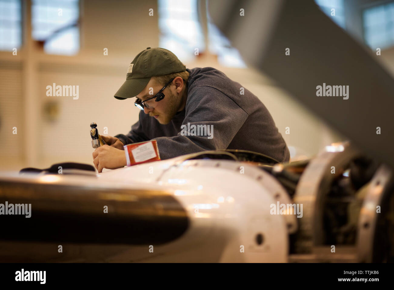 Side view of man working in aerospace industry Stock Photo