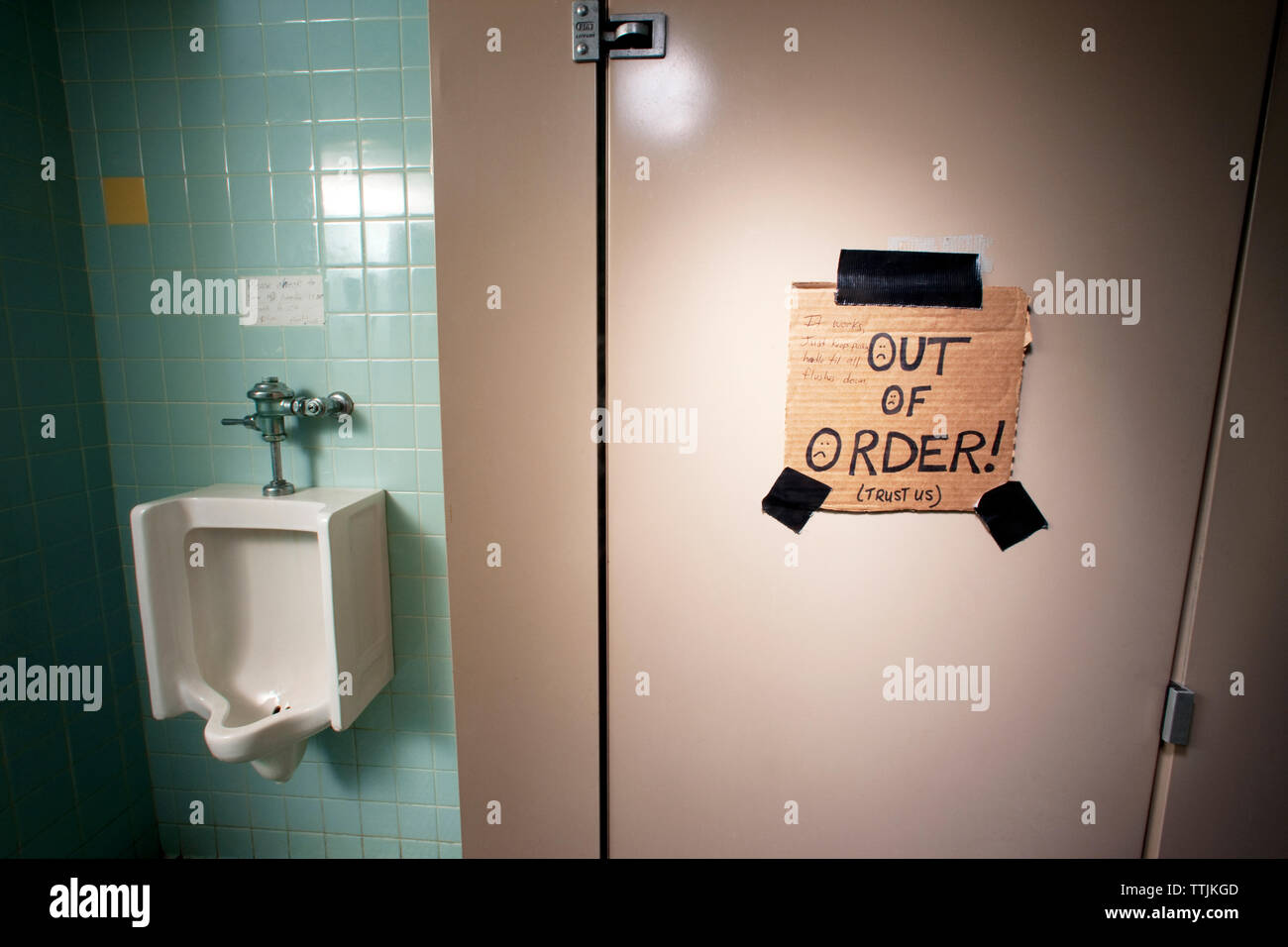 Text on door of public restroom Stock Photo
