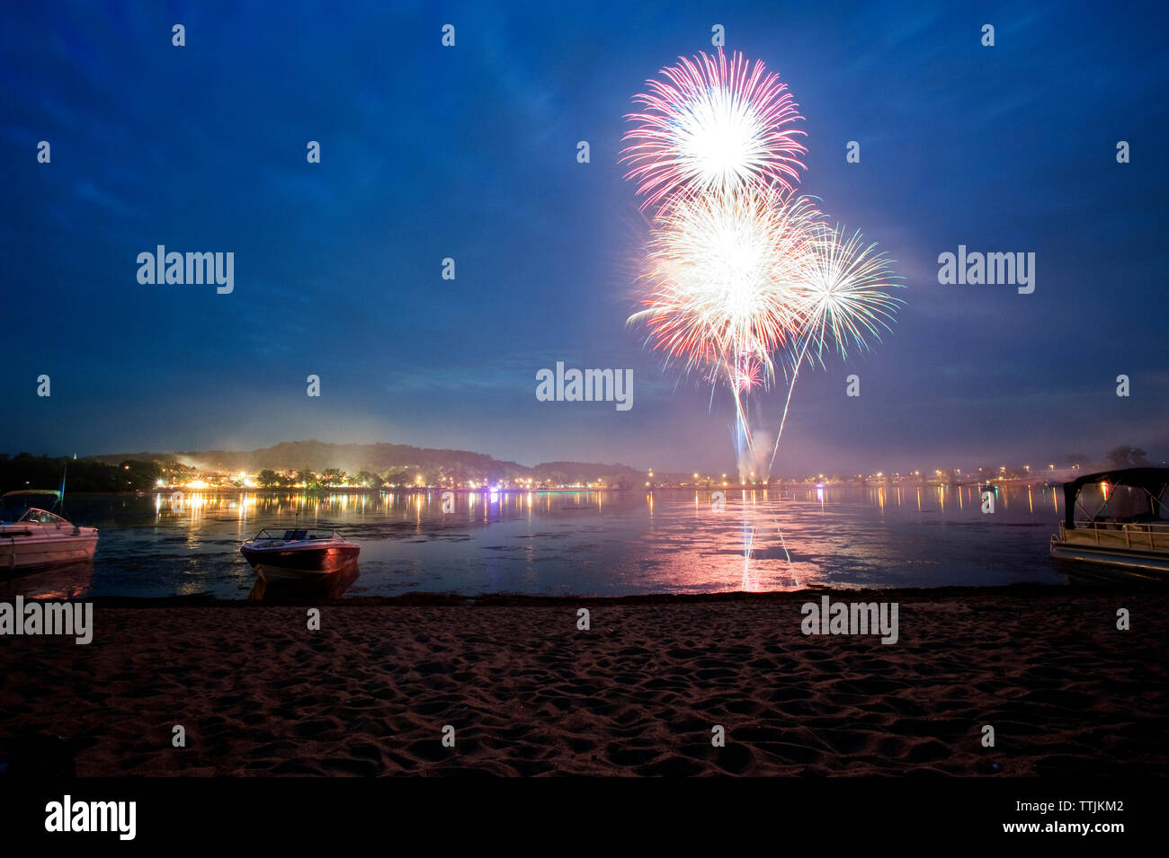 Fireworks display in sky over sea Stock Photo - Alamy