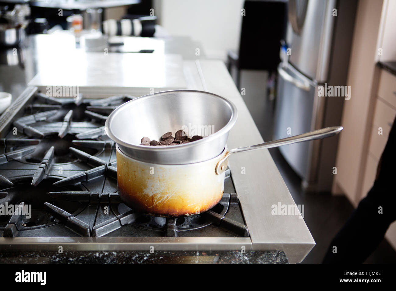 Chocolate chips in double boiler on stove Stock Photo