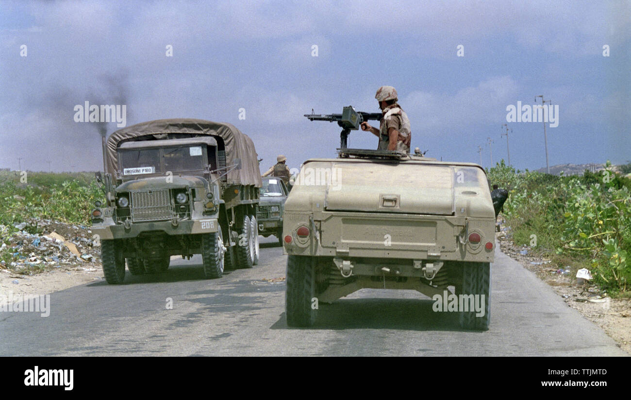 5th November 1993 Heading north, towards Mogadishu, Somalia, an American soldier mans an M60 machine gun on top of his Humvee as it passes a Pakistani United Nation convoy. Stock Photo