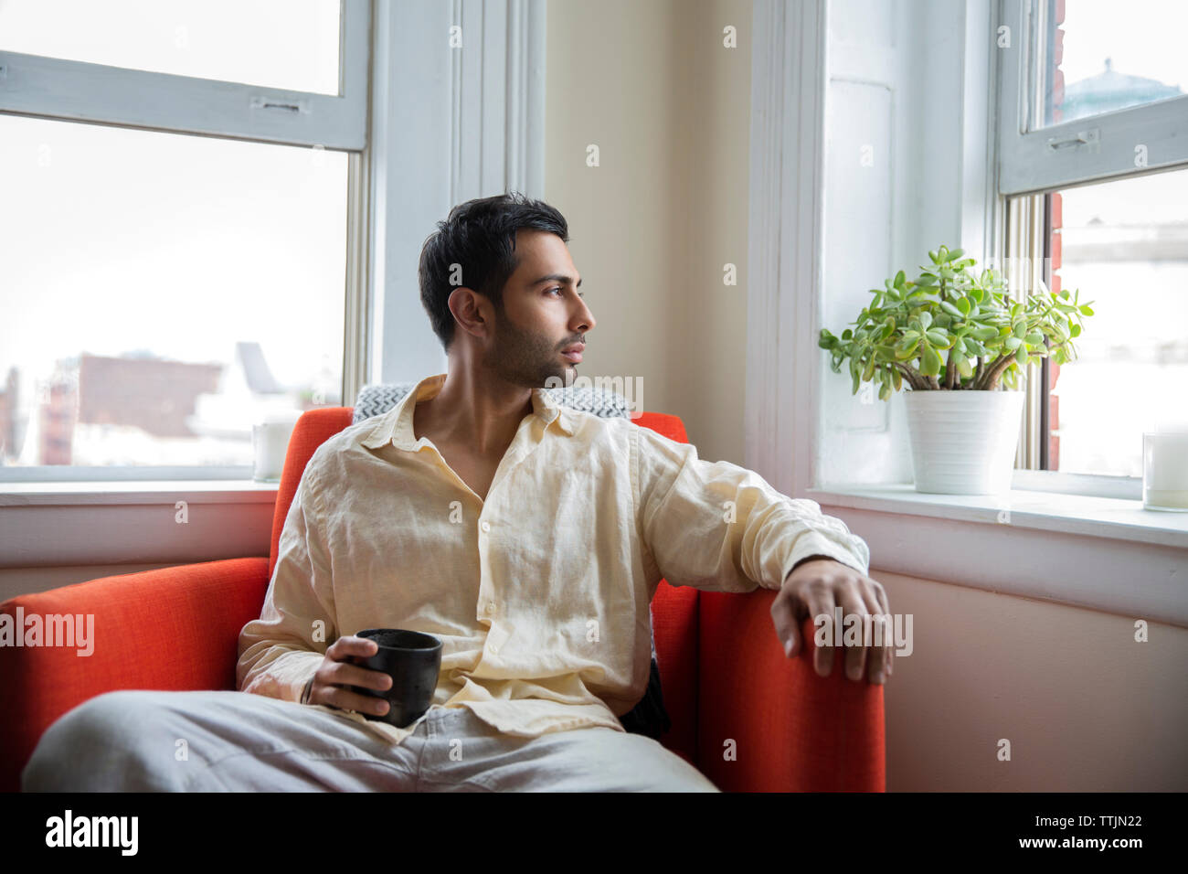 Indian man sitting home on hi-res stock photography and images - Alamy