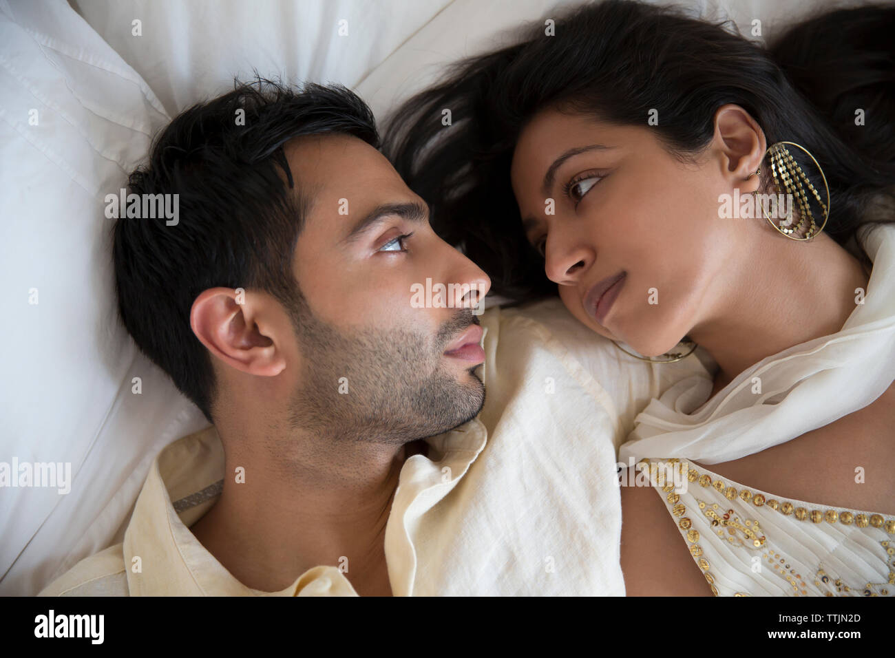 Overhead view of couple relaxing in bed at home Stock Photo