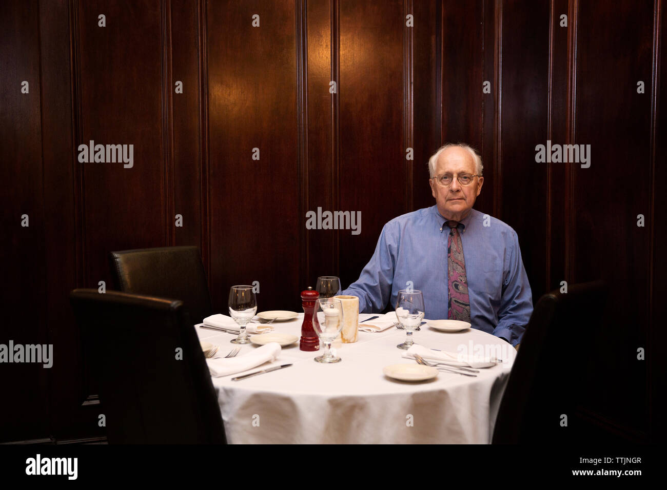 Portrait of senior man sitting in restaurant Stock Photo