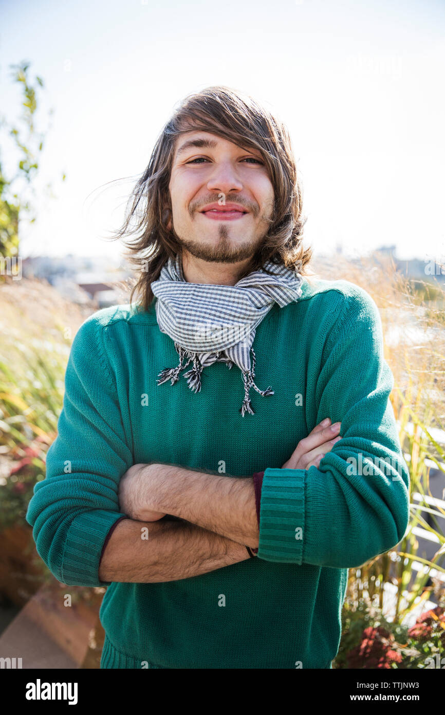 Portrait of smiling man standing arms crossed at yard Stock Photo - Alamy