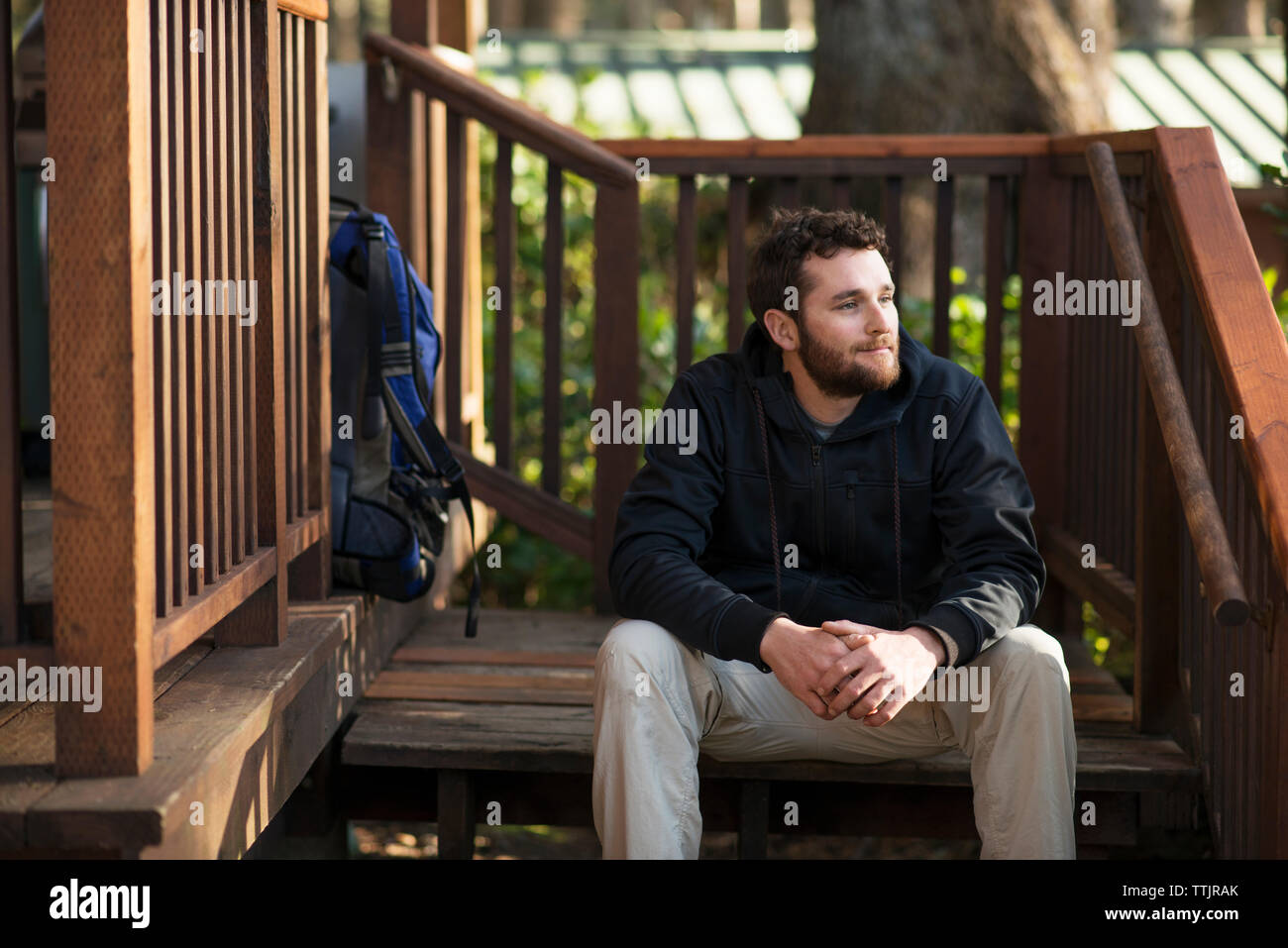Man looking away while sitting on steps Stock Photo