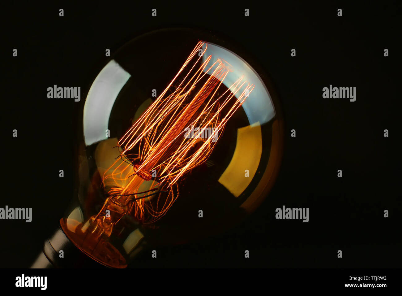 Illuminated light bulb on black background Stock Photo Alamy