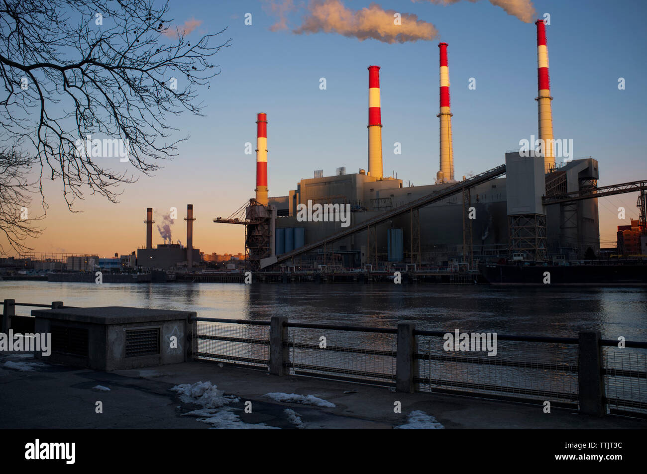Smoke Stacks in factory against clear sky Stock Photo