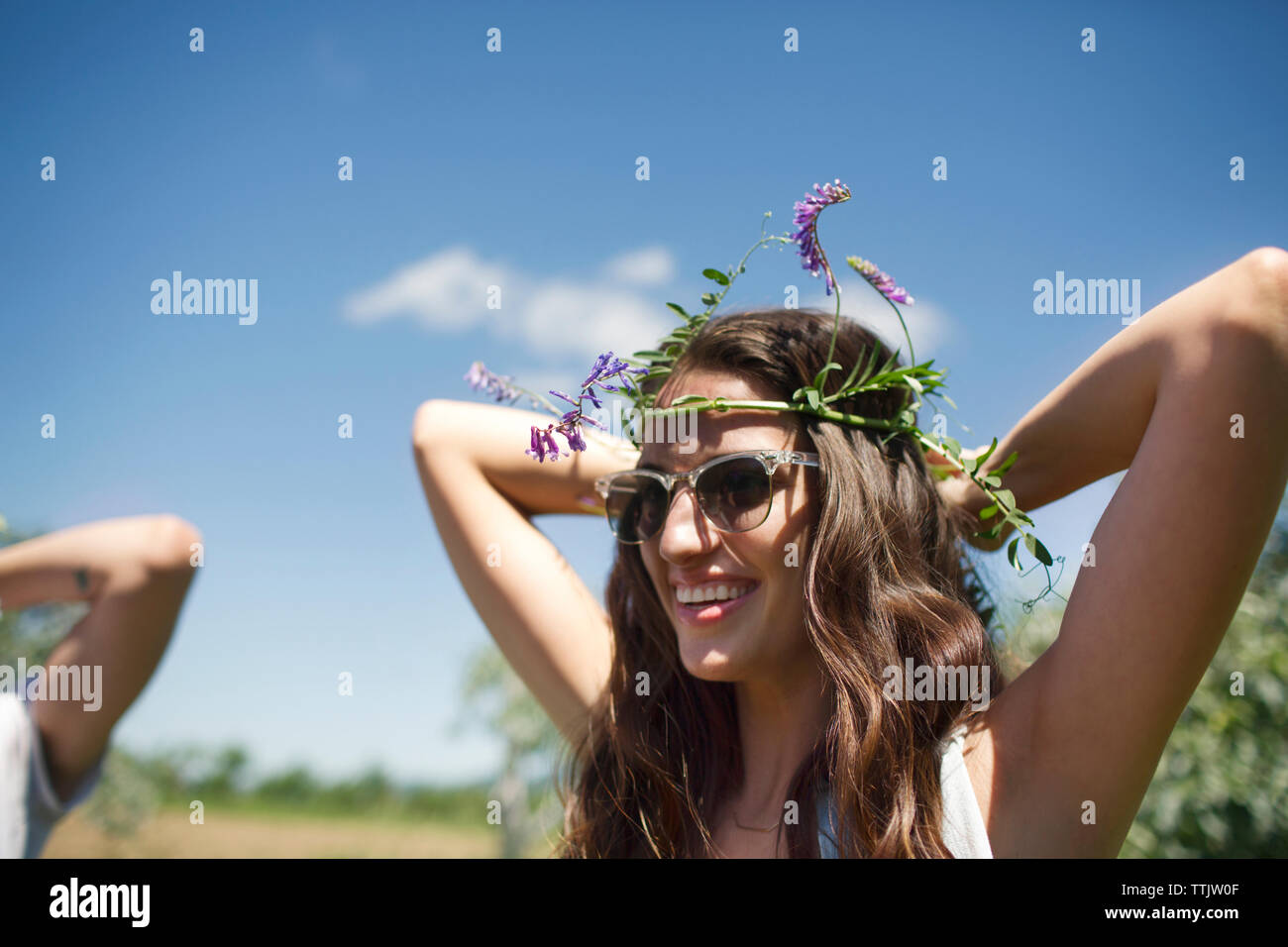 Happy woman wearing tiara while standing against blue sky Stock Photo