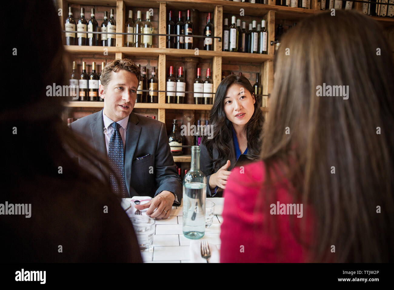 business people discussing while sitting in restaurant Stock Photo