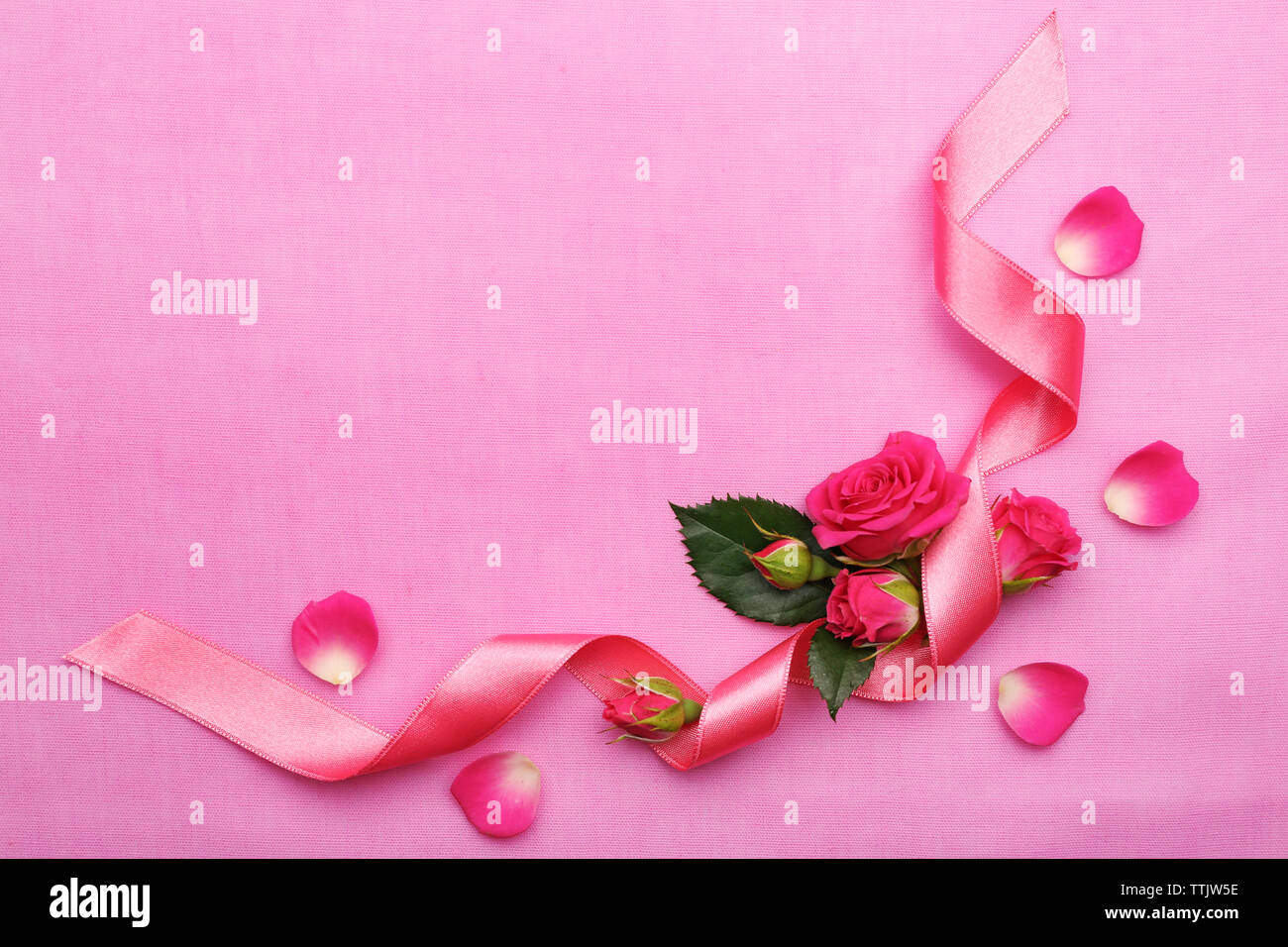 Fresh roses with ribbon on pink background Stock Photo - Alamy