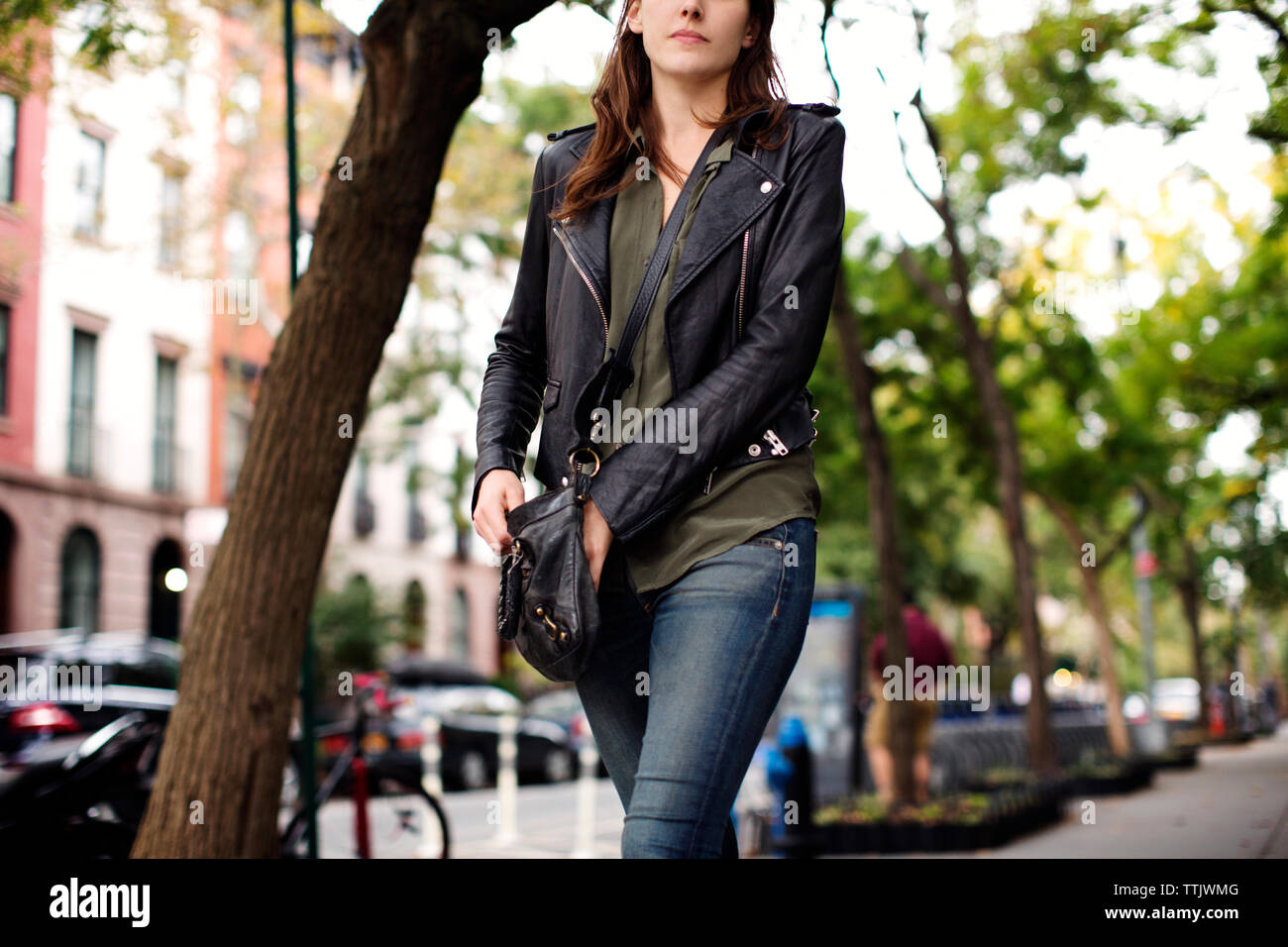 Woman walking sidewalk hi-res stock photography and images - Alamy