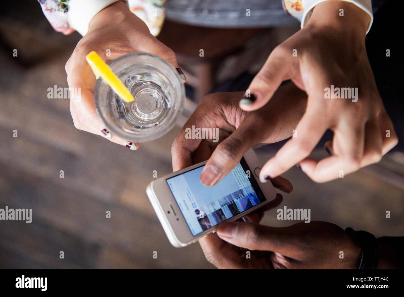 High angle view of friends using smart phone Stock Photo