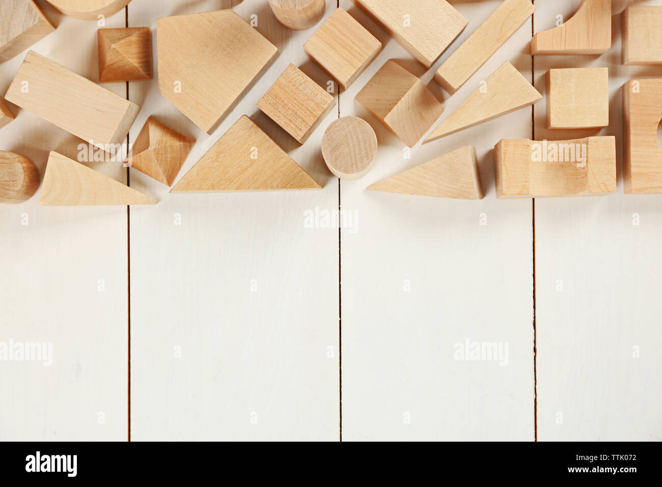 Wooden children's cubes on white wooden background Stock Photo - Alamy