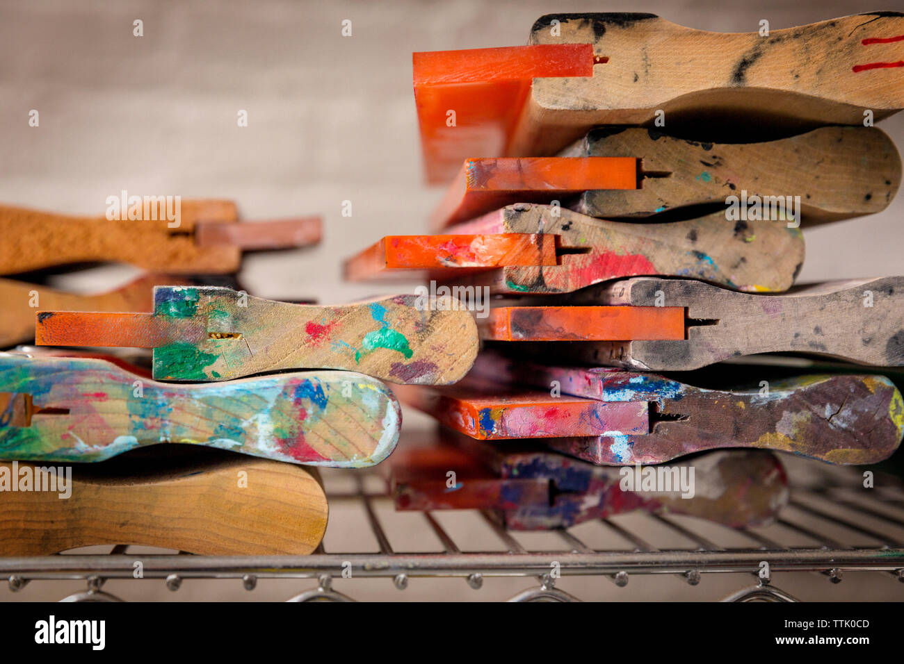 Close-up of squeegees on stand in workshop Stock Photo