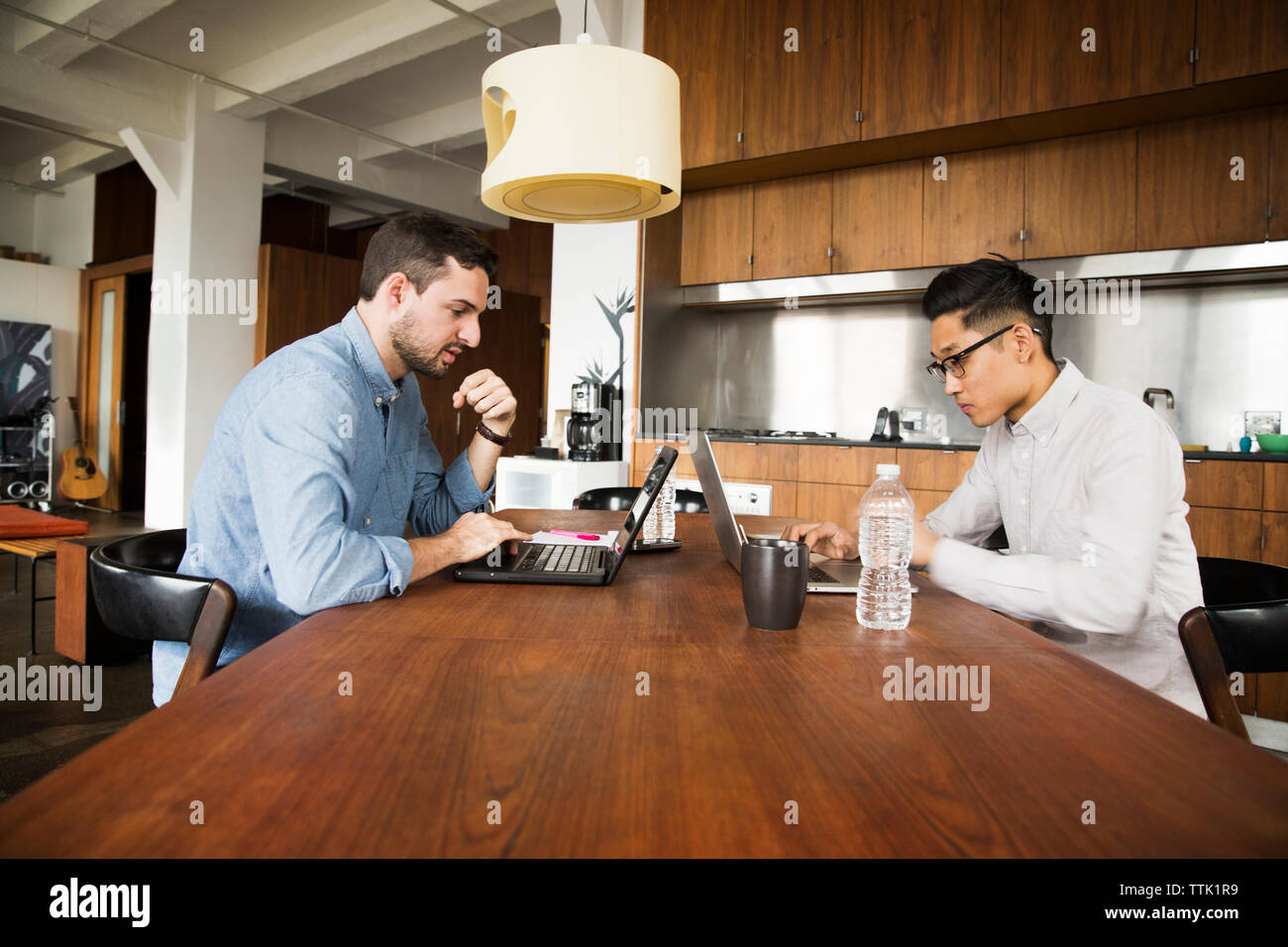 business partners using laptop computer on table at creative office Stock Photo