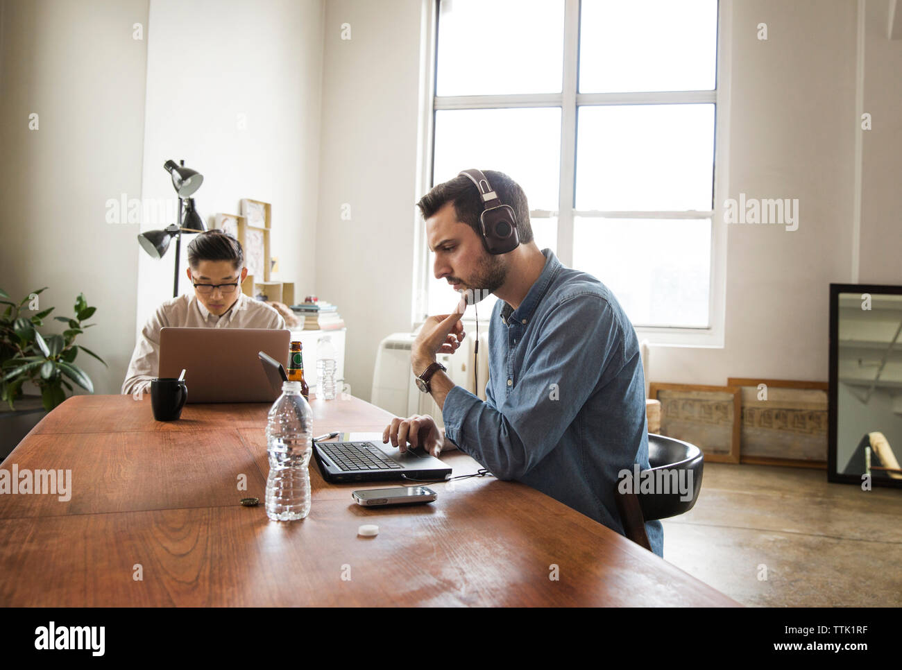 business colleagues using laptop computer at creative office Stock Photo