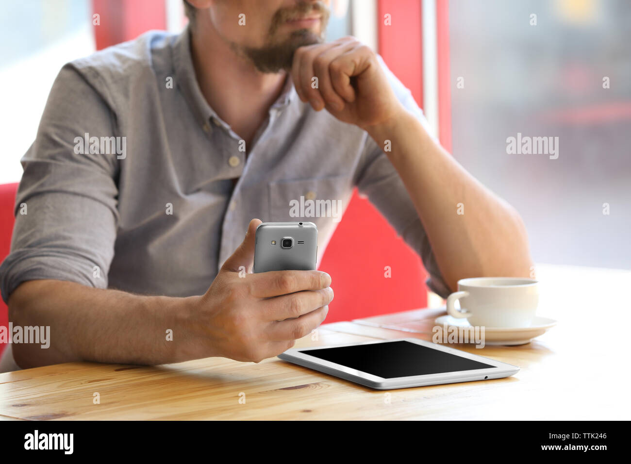 Businessman with gadgets in cafe Stock Photo