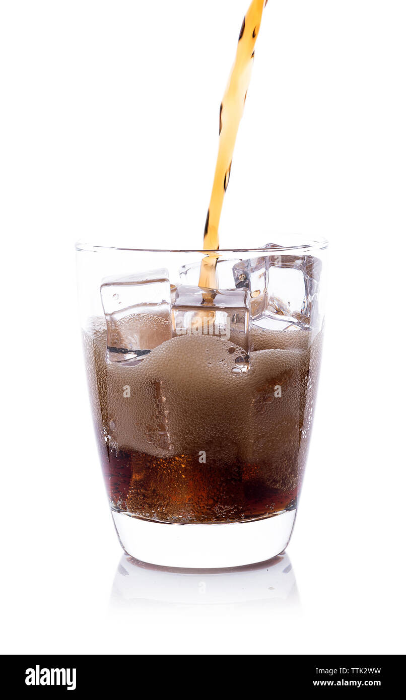 Bottle pouring Cola in drink glass with ice cubes Stock Photo - Alamy
