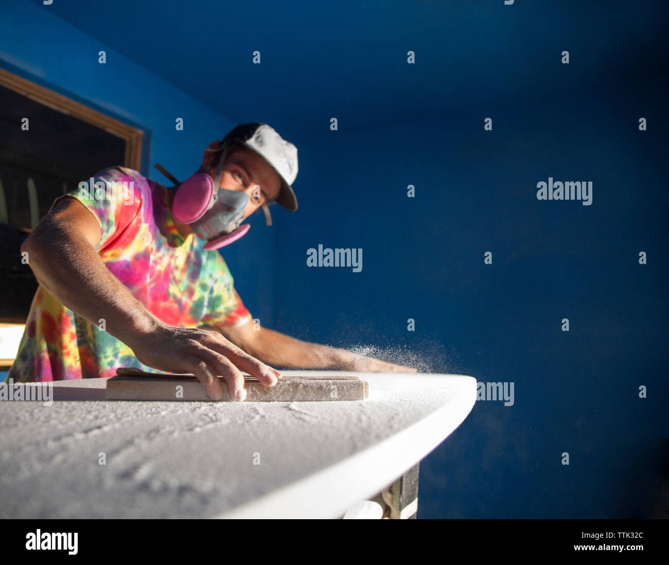 Man making surfboard in workshop Stock Photo
